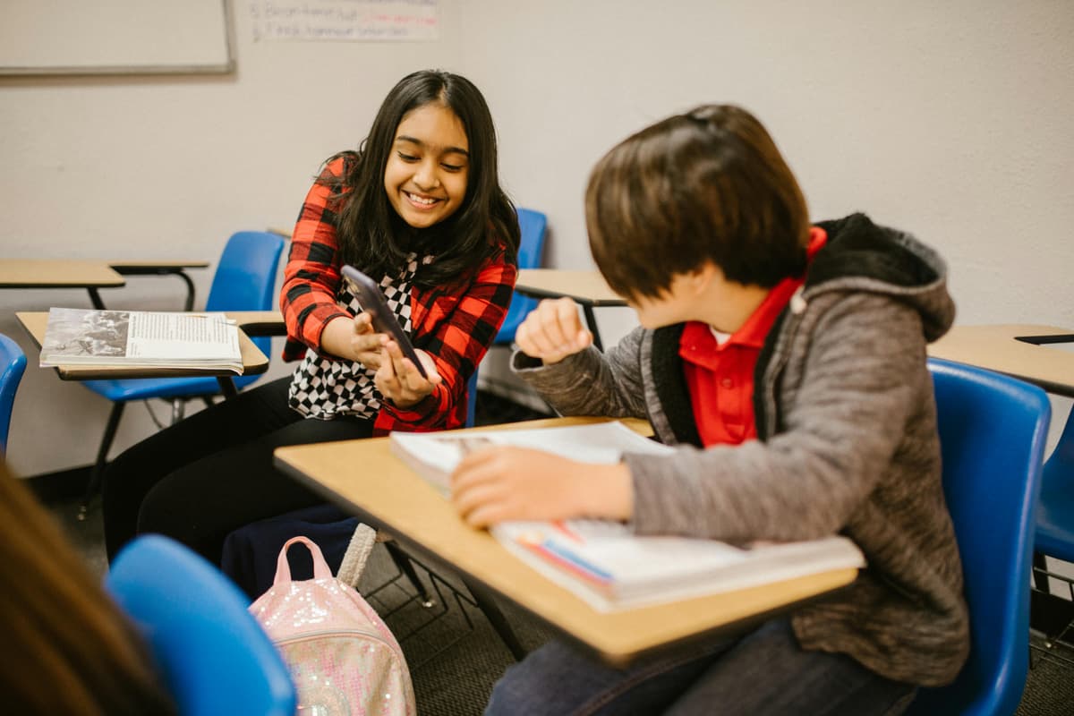 Students talking with an adult about online bullying and kindness